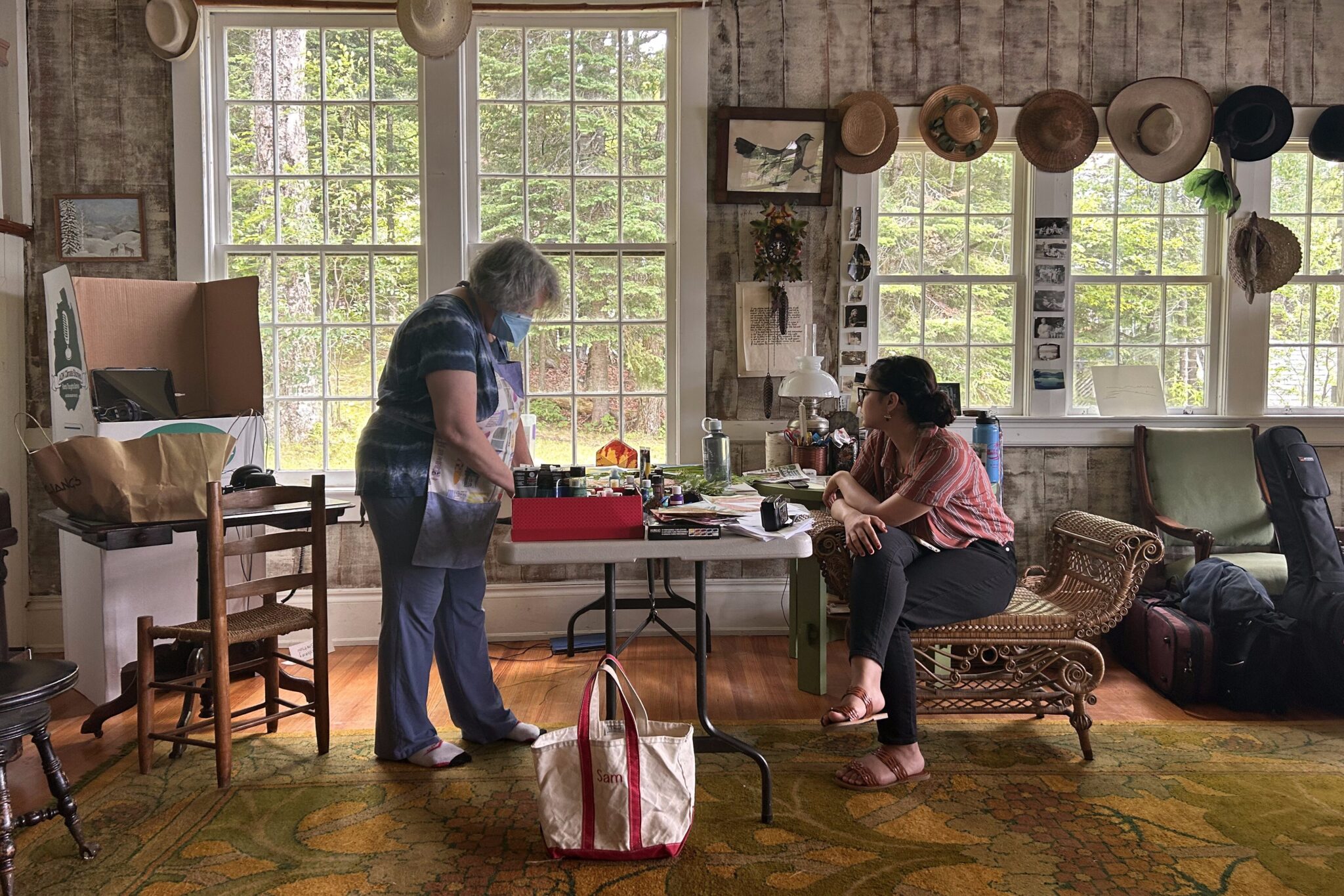 Two people at a desk working and talking.